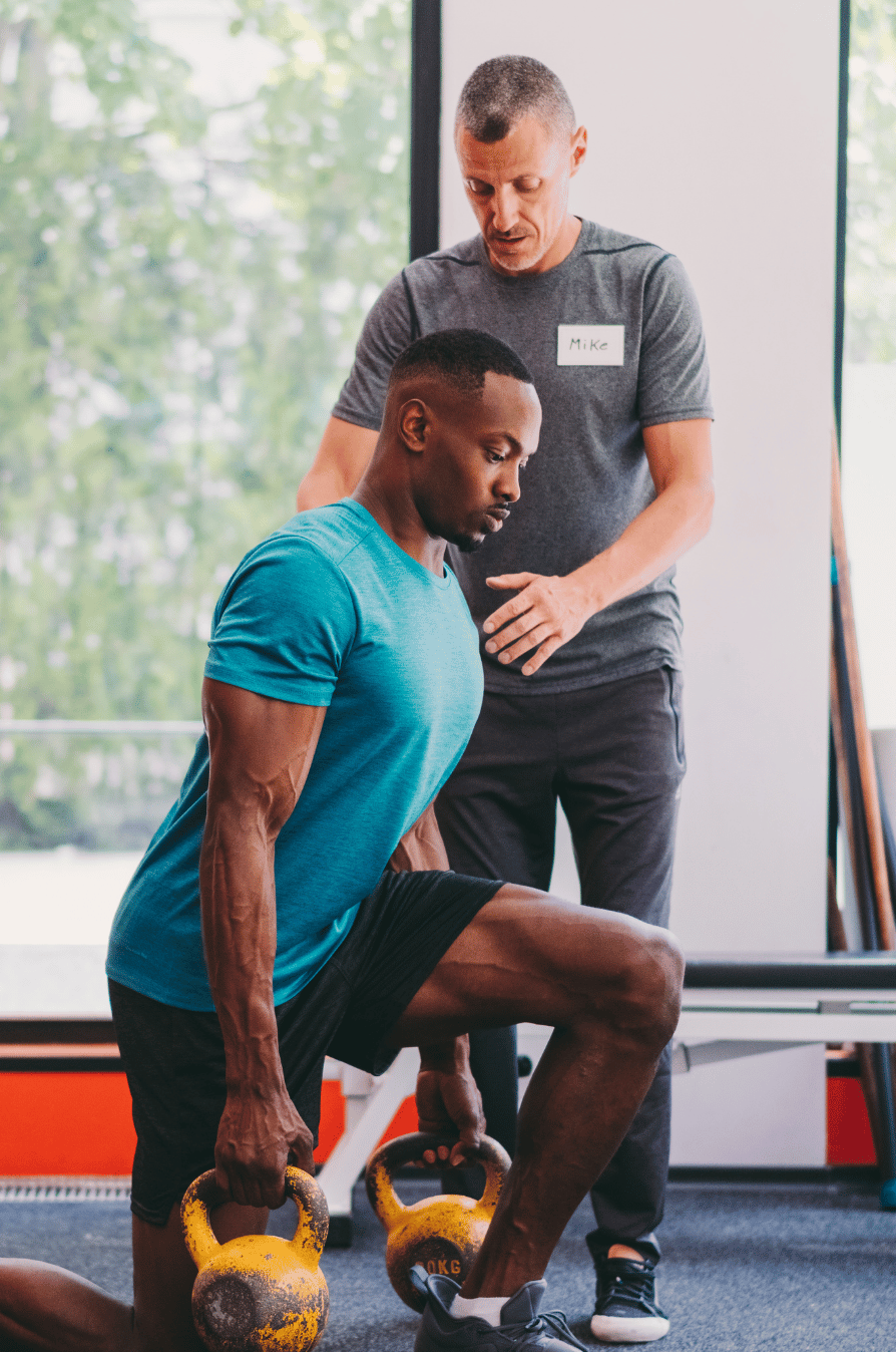 Personal trainer coaching a client